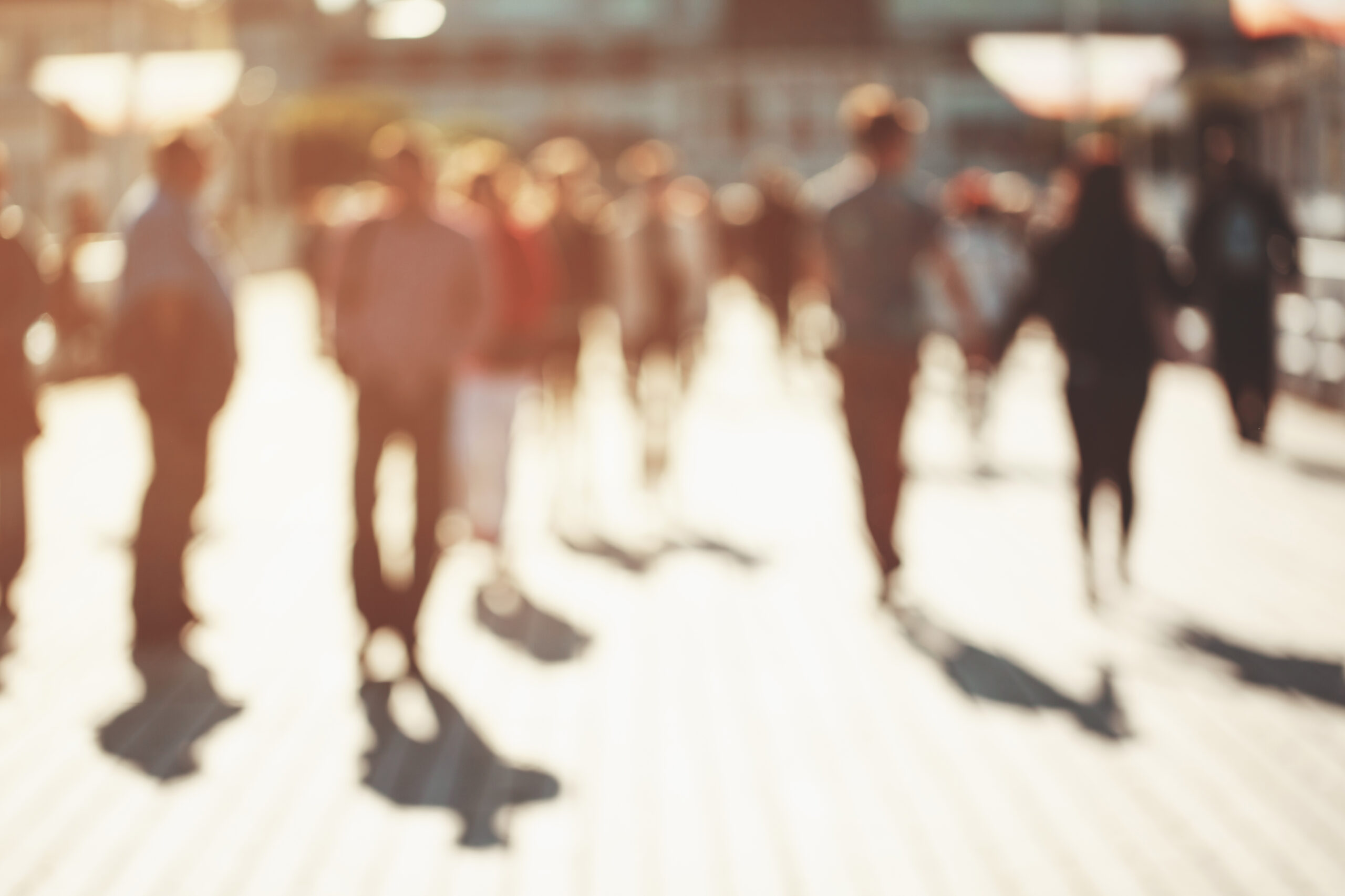 Blurred background of unrecognizable persons walking along the pier in Sopot, Poland. Vintage toning.